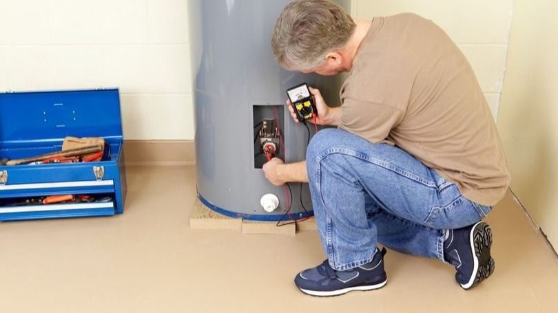 plumber working on a hot water heater
