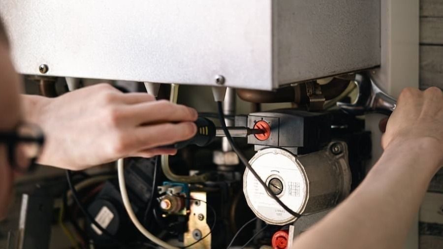HVAC technician working on a home heating system