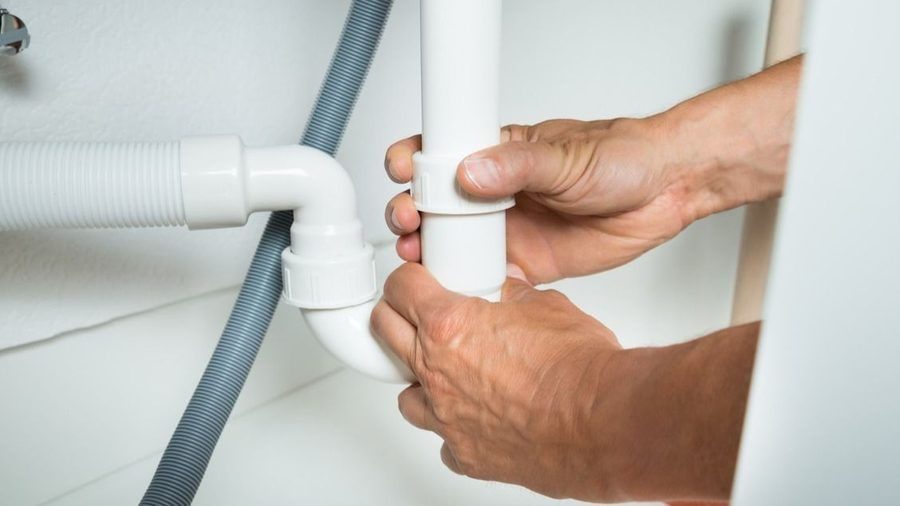 plumber fixing a pipe