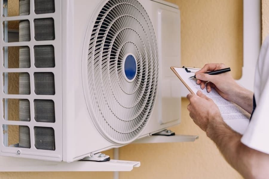 Heating service in Madison and Greater Wisconsin with technician working on home heating system.