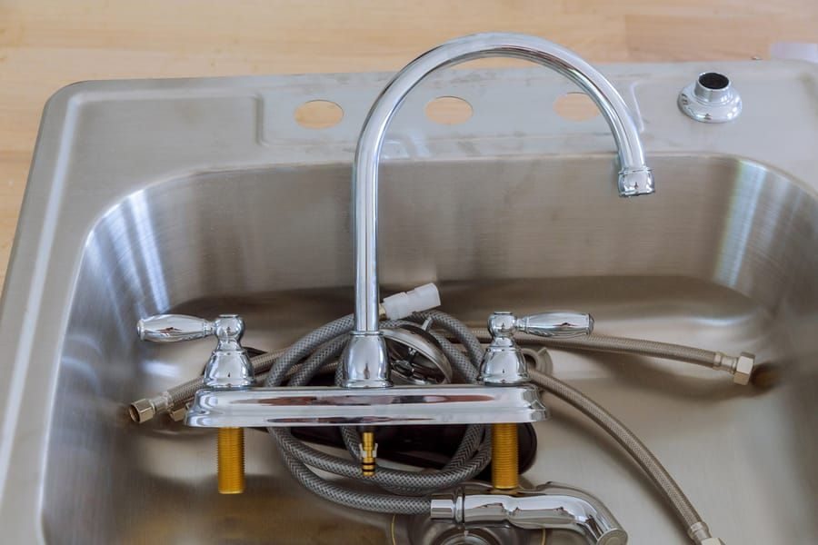 Plumbing fixture installation in Madison and Greater Wisconsin with sink and faucet setup.