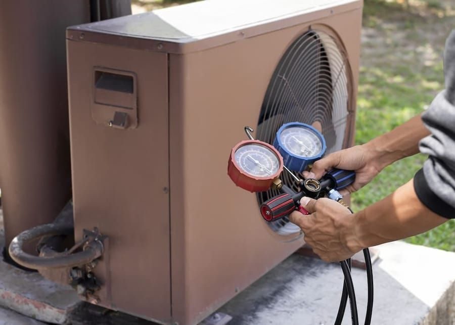 Heat pump service in Madison and Greater Wisconsin with technician servicing heating system.