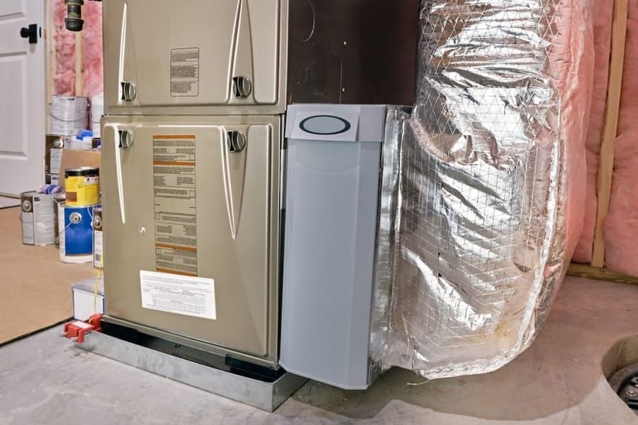Heating service in Madison and Greater Wisconsin with technician working on home heating system.