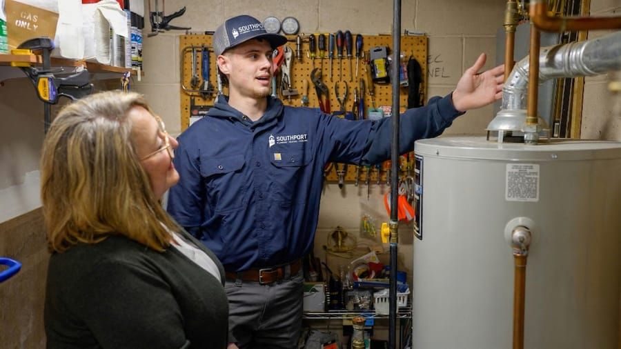 Plumbing services in Madison and Greater Wisconsin with technician working on residential water system.