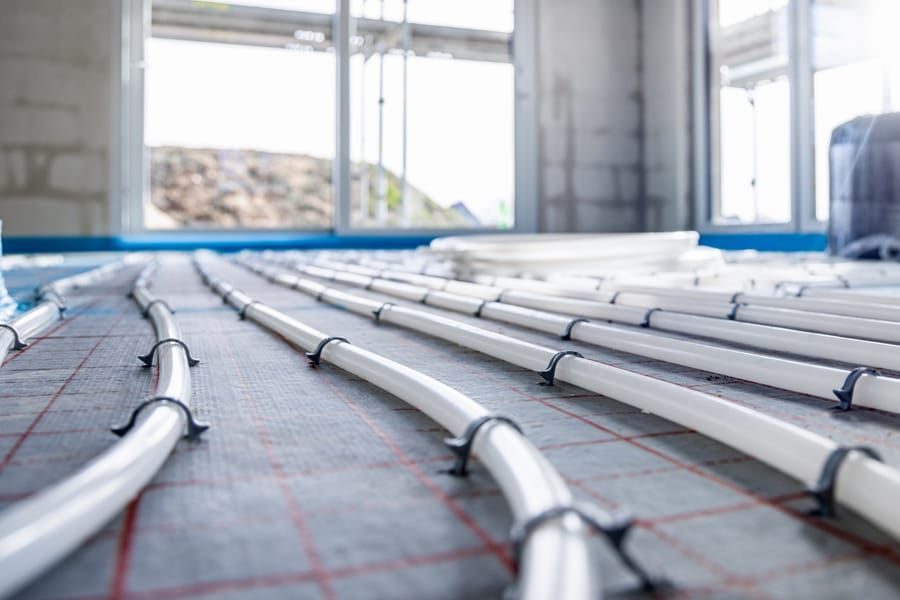 Radiant heating installation with the piping showing before Southport completes install.