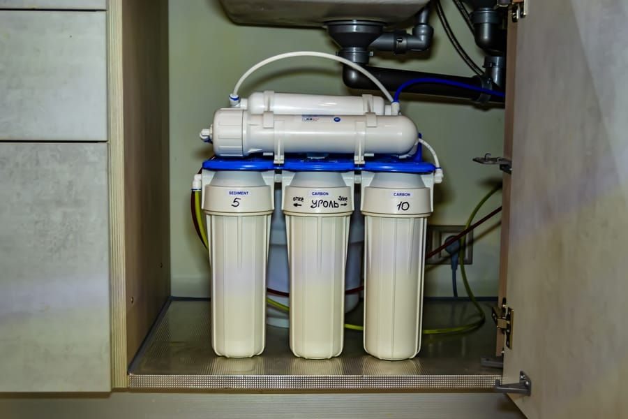 Water filtration installed in a residential home under the sink.