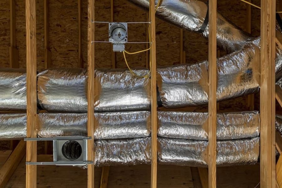 Professionally upgraded ductwork in a commercial attic.
